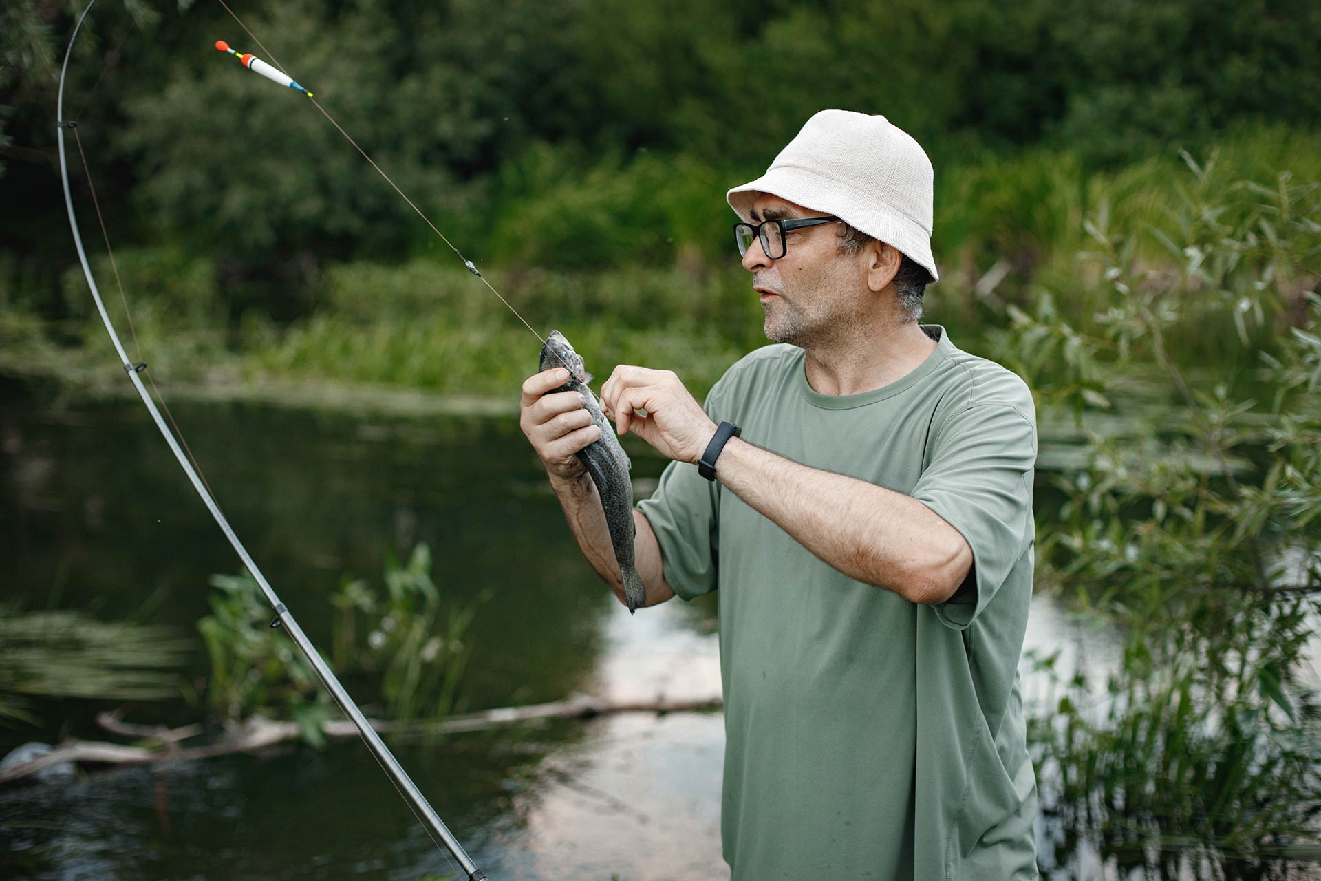 fisherman-with-fishing-rod-near-the-lake-at-summer.jpg