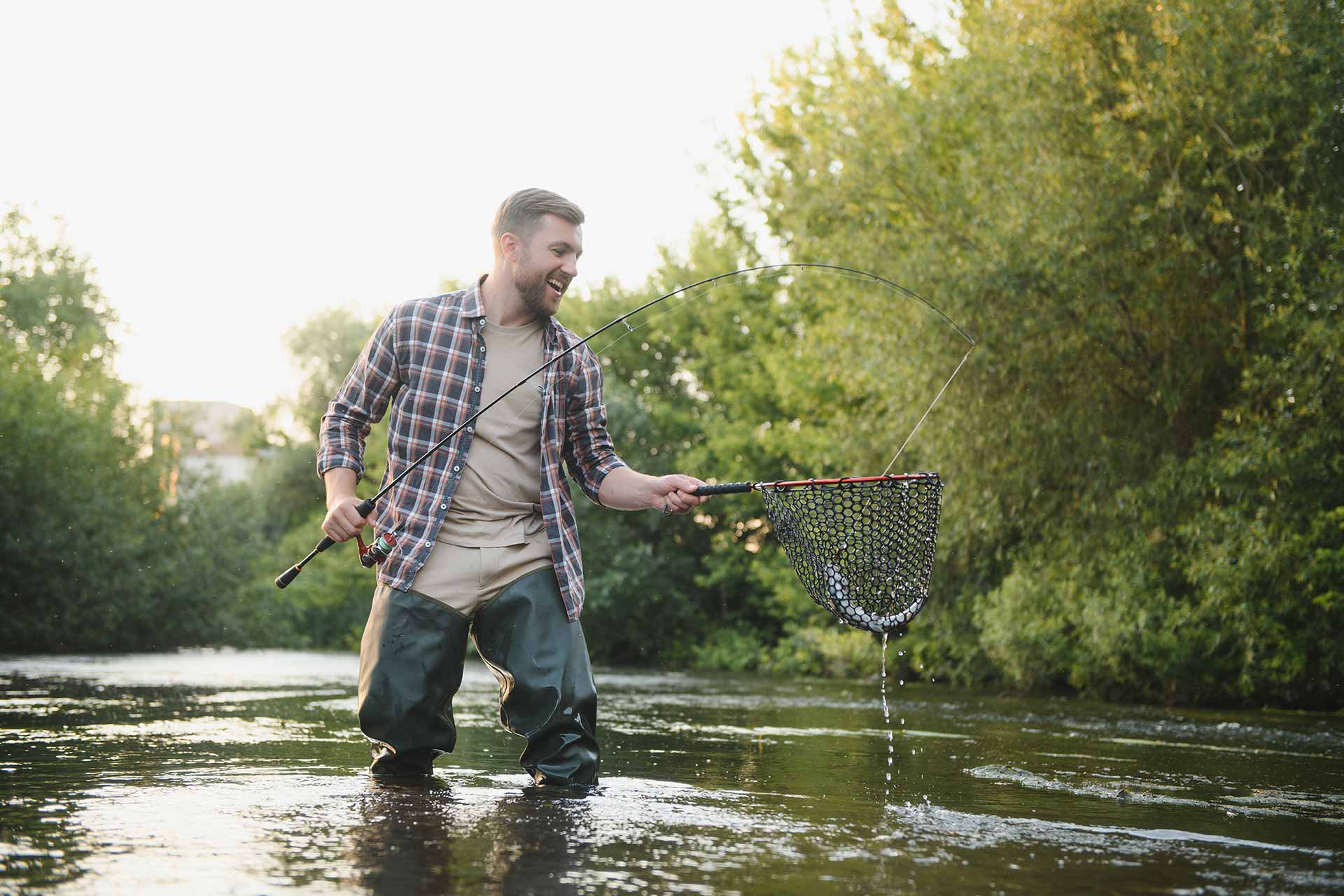 man-with-fishing-rod-fisherman-men-in-river-water.jpg